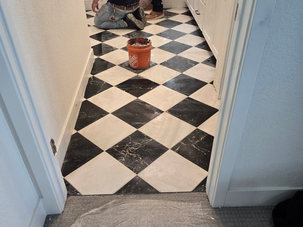Completed bathroom with black-and-white checkerboard floor tile.