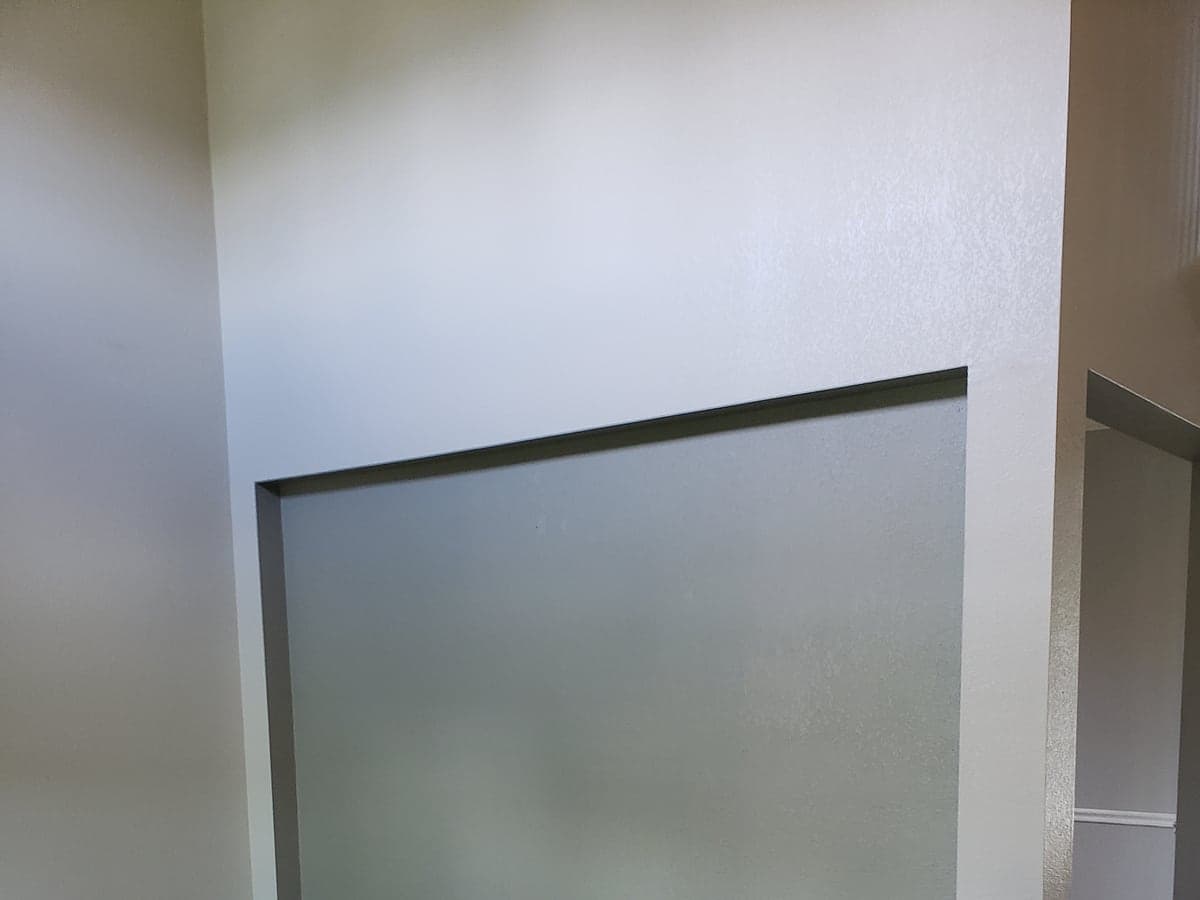 White subway-tile backsplash installed across a kitchen wall with a level layout.
